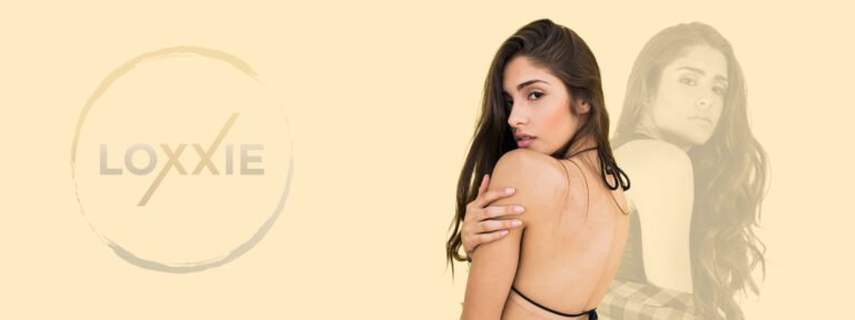 A woman in a bikini top and a man in a suit are featured together, promoting Loxxie Hair's fashionable appeal.