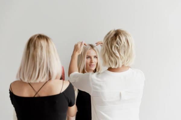 Three women pose together, proudly displaying their Loxxie hair, radiating joy and friendship.