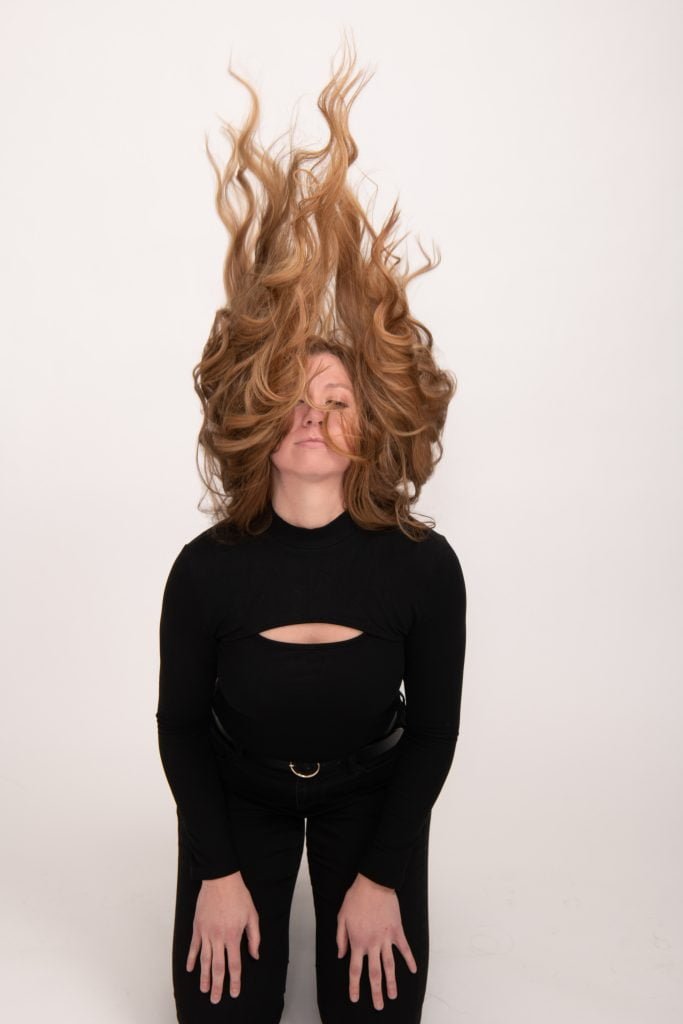 A trio of women standing closely, all featuring vibrant Loxxie hair, exuding confidence and camaraderie.