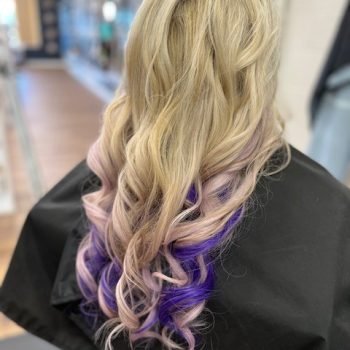 A woman with long, flowing blonde hair, featuring Loxxie hair products for a vibrant and healthy appearance.