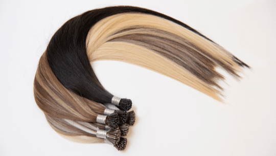 A collection of Loxxie Hair extensions with a combination of blonde and black hair for added length and volume.