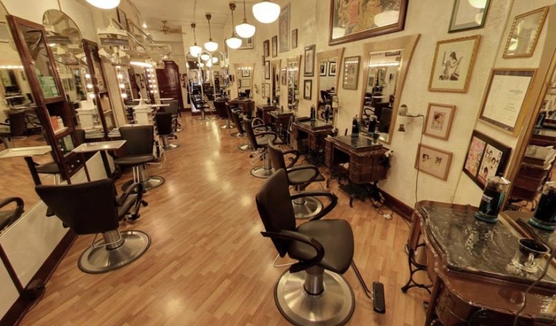 A long row of stylish chairs in Loxxie Hair salon, ready for clients to receive hair treatments and styling services.