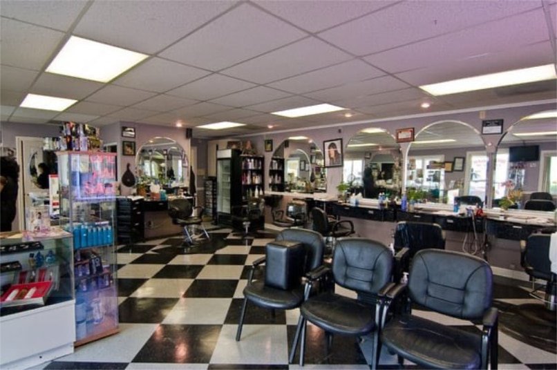 Loxxie Hair salon with a modern layout, displaying chairs and mirrors prominently in the middle of the room.
